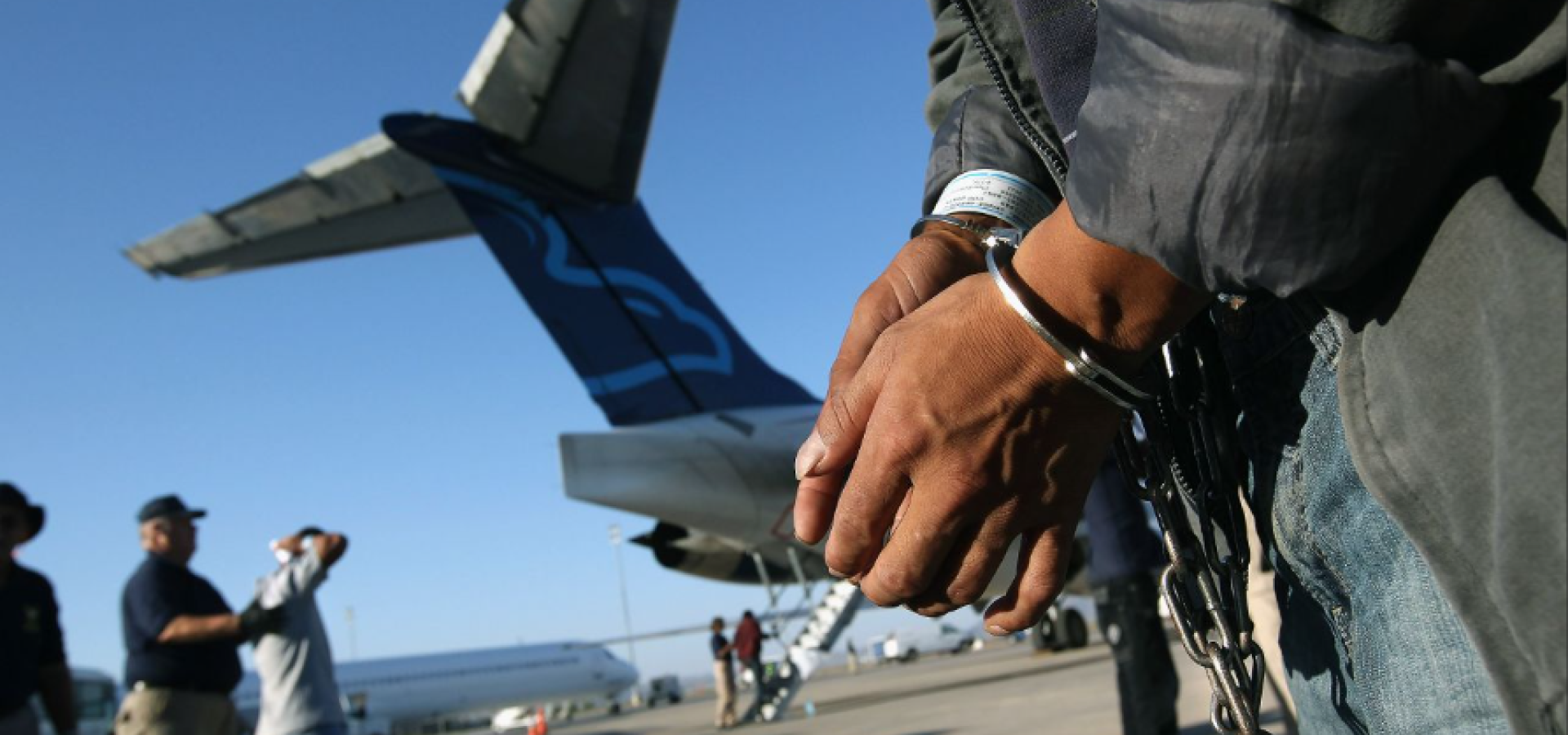 Illegal alien in handcuffs being deported